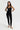 Sleek long jumpsuit black in model front view - JUV