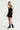 Sleek short jumpsuit black in model front side view - JUV