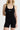 Sleek short jumpsuit black in model front view close up - JUV