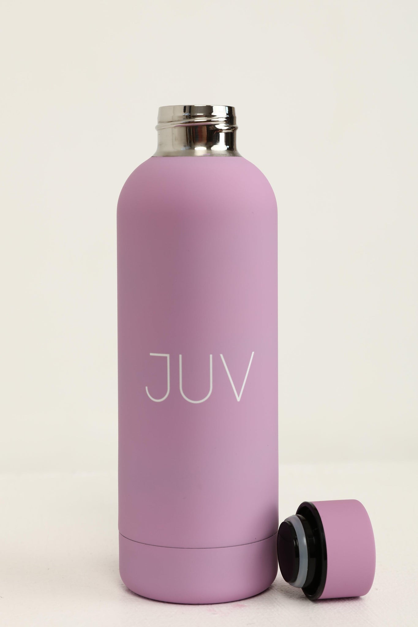 JUV mia thermal bottle in purple with the cup on the side, front view.